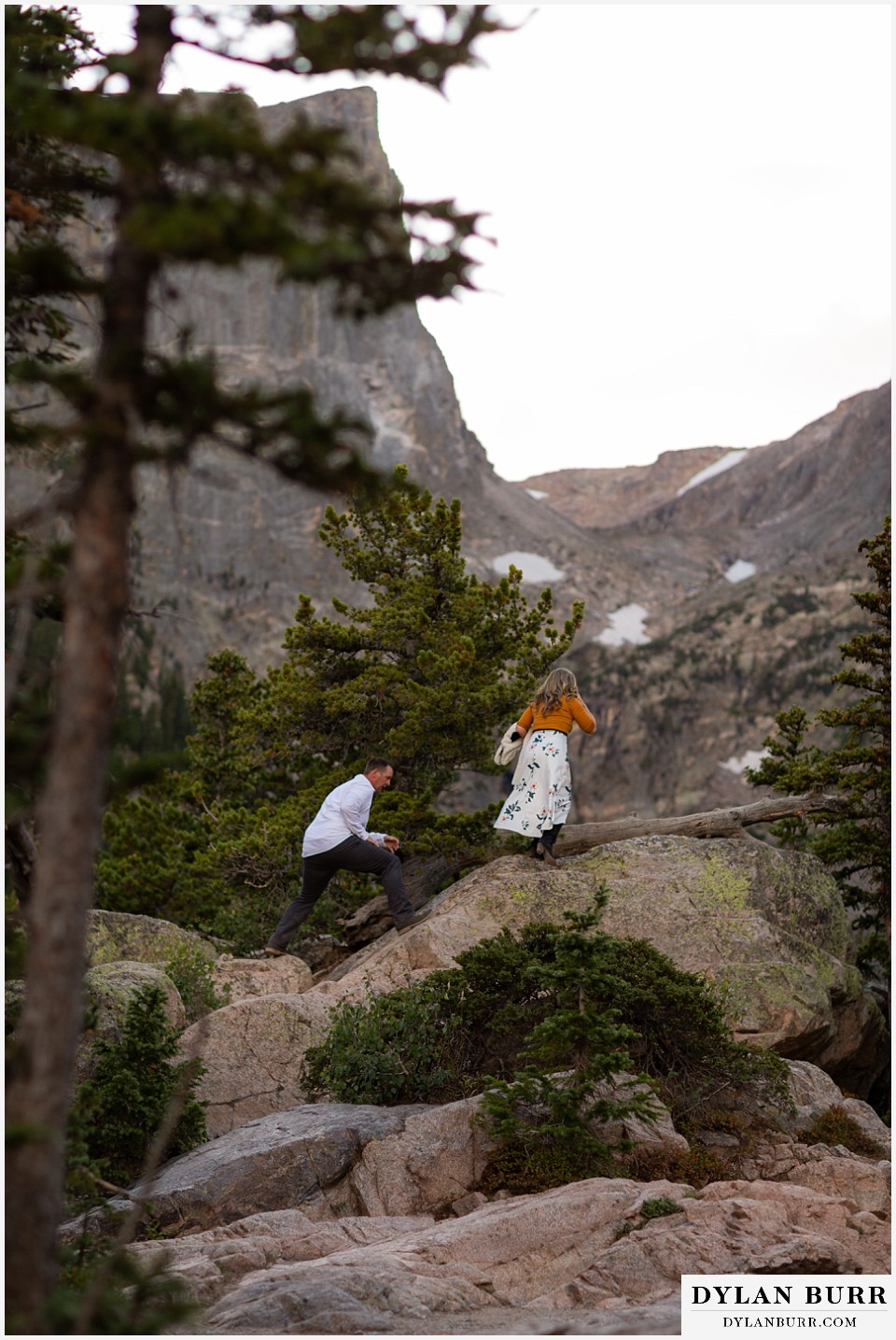 rocky mountain national park elopement wedding bride and groom hiking in snow capped mountains