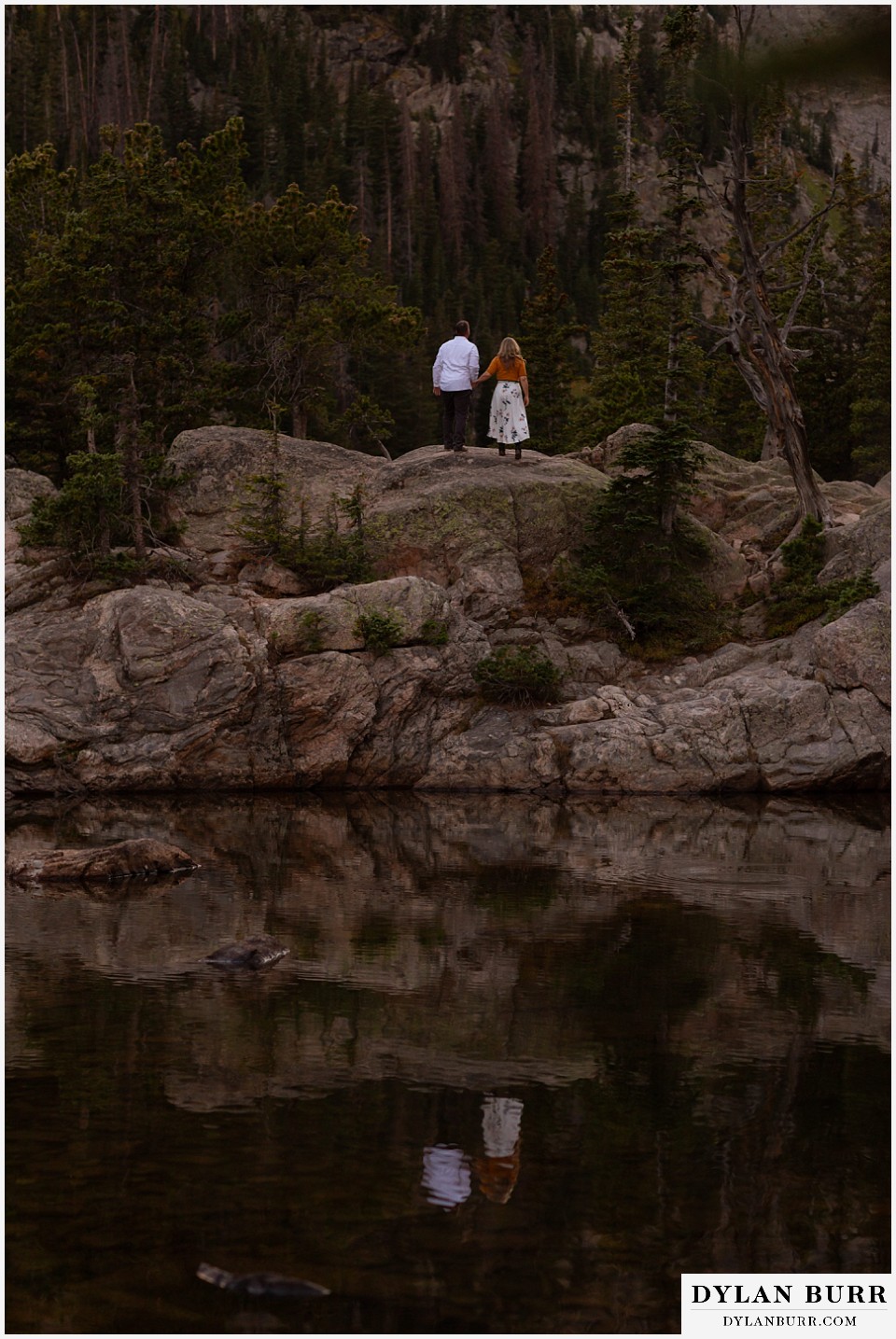 rocky mountain national park elopement wedding couple watching the sunset at a mountain lake