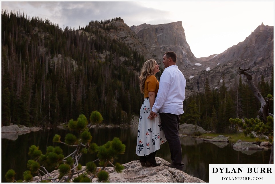 rocky mountain national park elopement wedding bride and groom by alpine lake at sunset