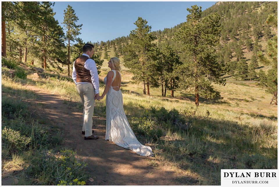 rocky mountain national park wedding elopement married bride and groom walk along a mountain trail