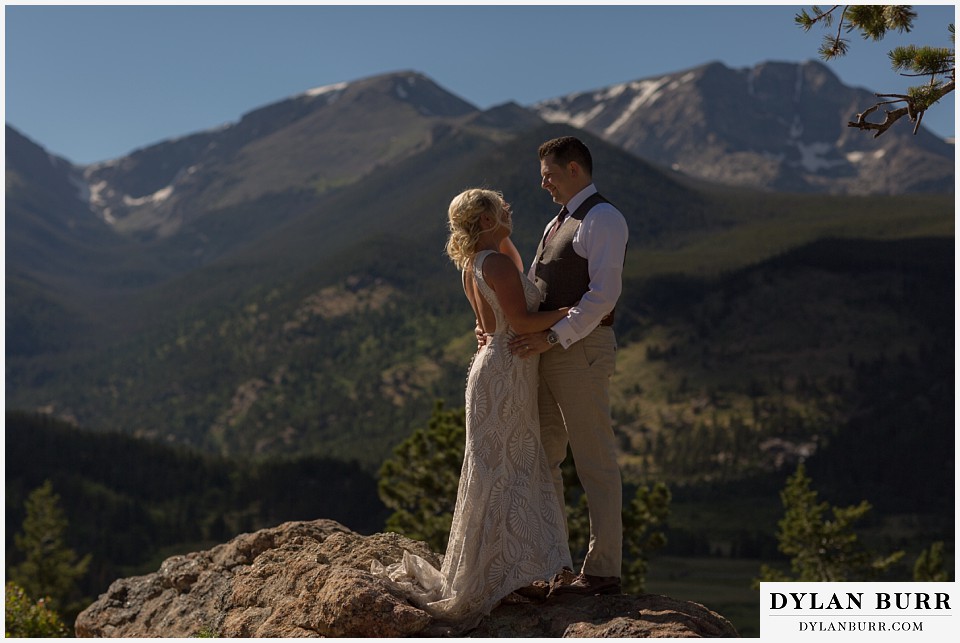 rocky mountain national park wedding elopement bride and groom take in the snow capped mountain views