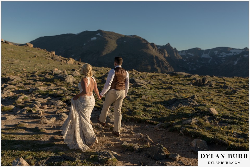 rocky mountain national park wedding elopement bride and groom walking on mountain alpine trail
