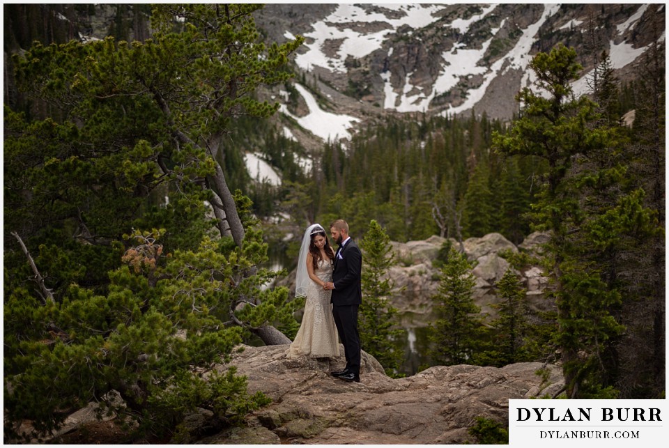 rocky mountain national park wedding elopement colorado wedding photographer dylan burr bride and groom in mountains and lakes taking a moment