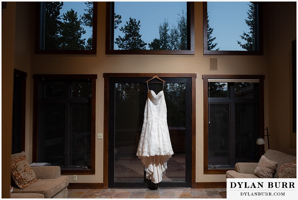wedding dress hanging in window