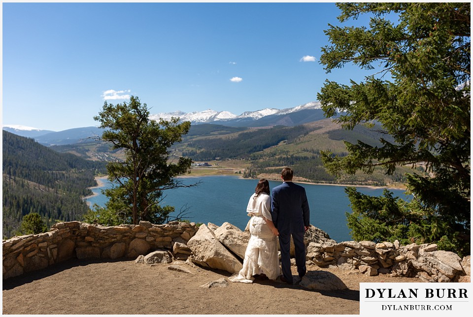 bride and groom looking out at dillon lake from sapphire point in breckenridge colorado