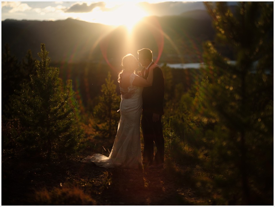 silverthorne elopement wedding couple at sunset with round lens flare