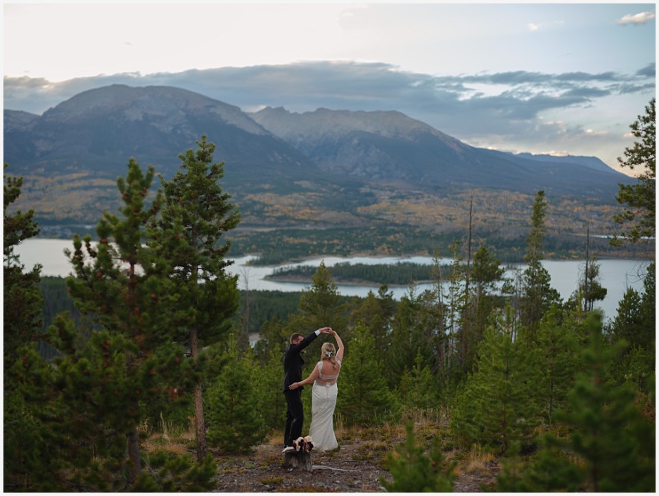 silverthorne elopement wedding dancing together in mountains with lakes in the background