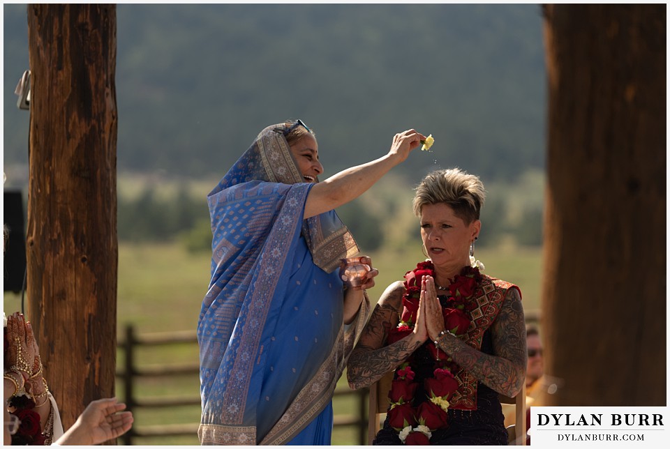 spruce mountain ranch wedding indian wedding sprinling water on brides mother