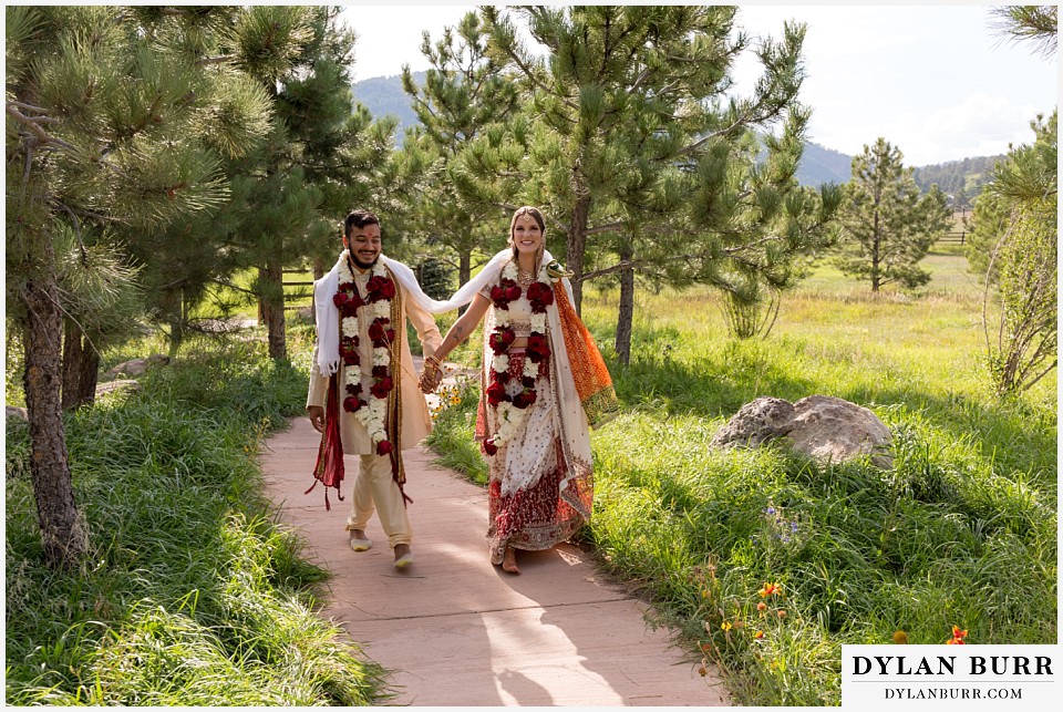 spruce mountain ranch wedding indian wedding happy bride and groom walking together