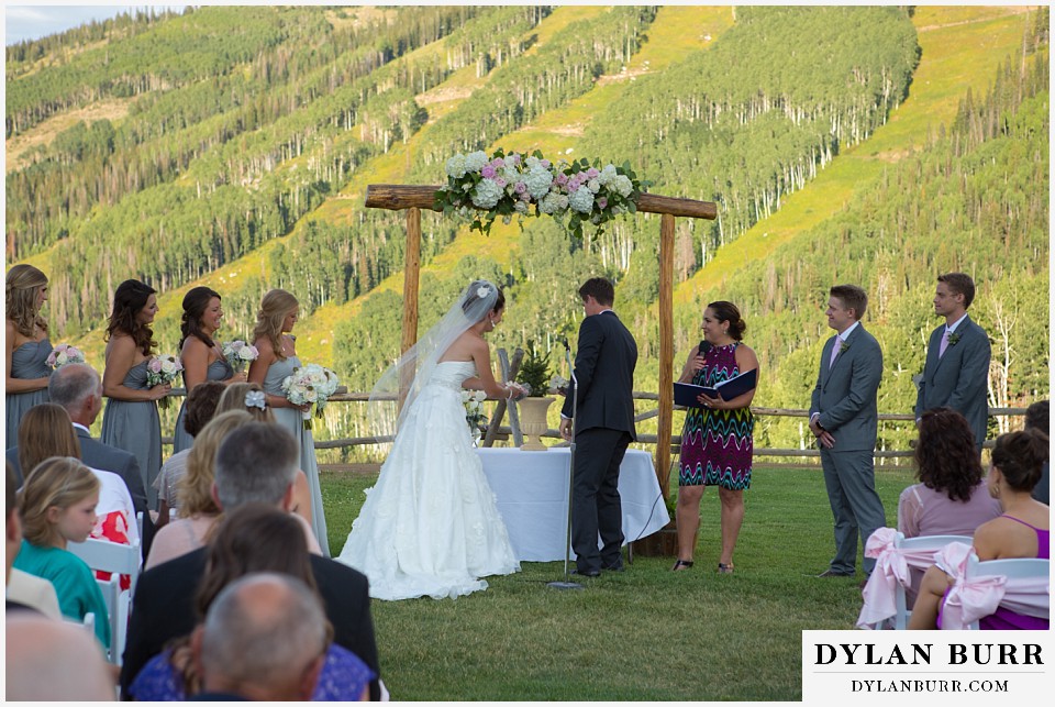 steamboat mountain weddings colorado bride and groom putting dirt into pot with pine tree