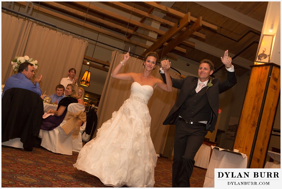 steamboat mountain weddings colorado bride and groom celebrating entering reception