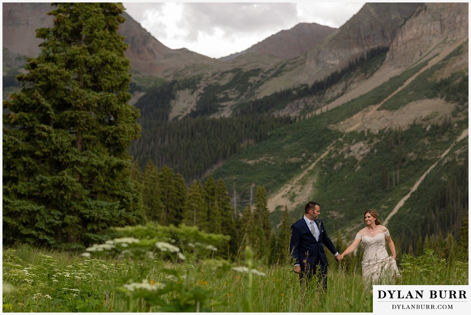 telluride colorado elopement wedding adventure bride and groom walking togeather in mountains