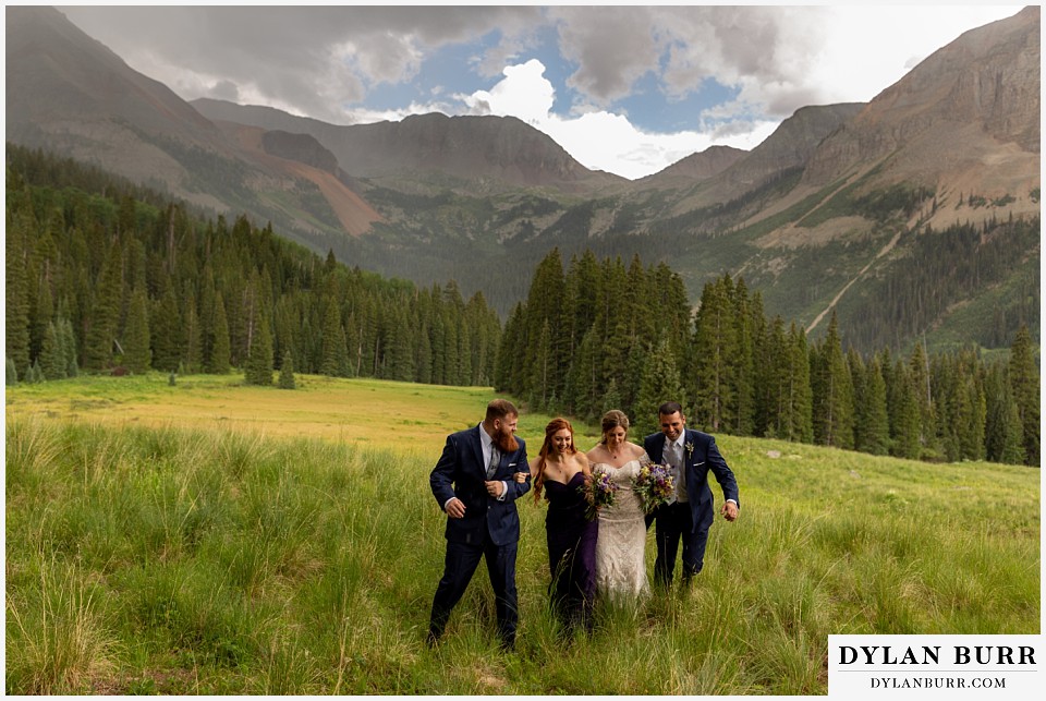 telluride colorado elopement wedding adventure bridal party together running in mountain rain