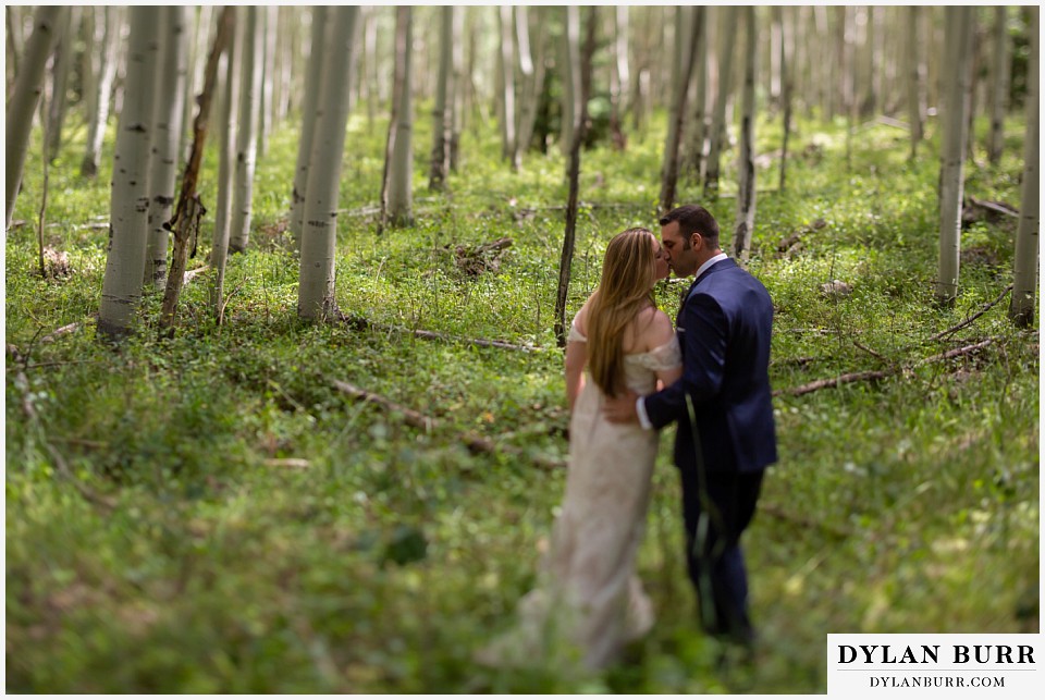 uncompahgre national forest colorado elopement wedding adventure bride and groom kissing in aspen trees tilt shift lens portrait