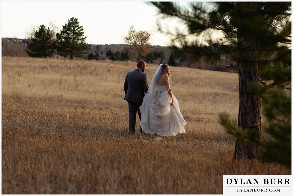 villa parker wedding parker colorado bride and groom walking out in field together