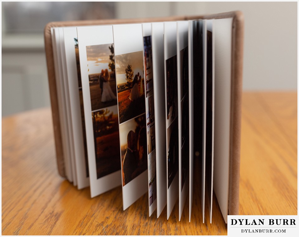 detailed close up of thick wedding album pages with custom design
