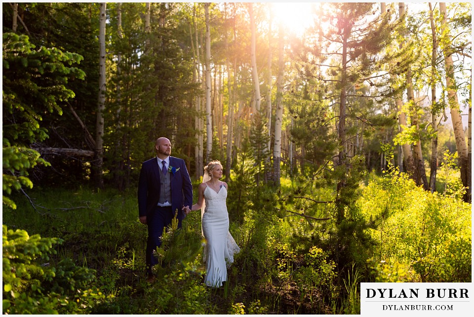 rocky mountain national park bride and groom walking in the sunlight