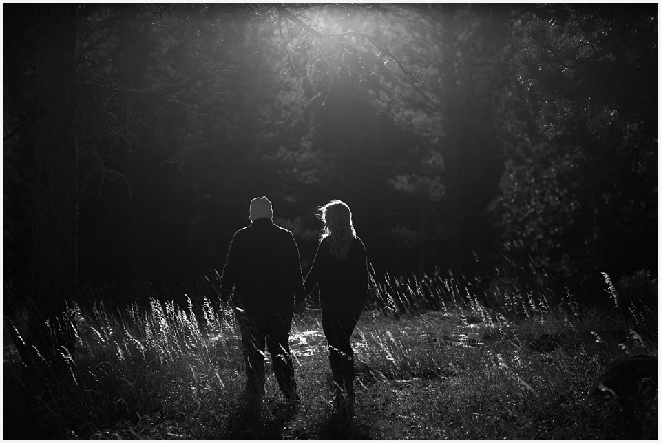engagement photos couple walking together in sunlight black and white