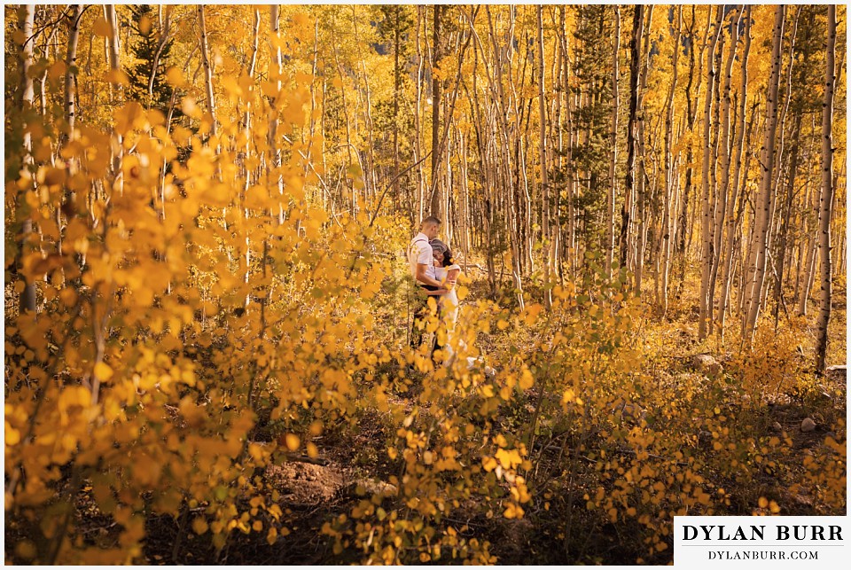 winter park mountain lodge wedding colorado bride and groom surrounded by yellow aspen trees