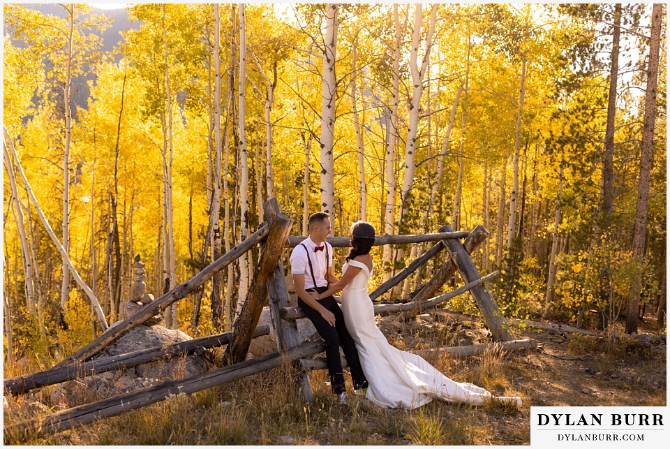 winter park mountain lodge wedding colorado bride and groom in forest near old fence