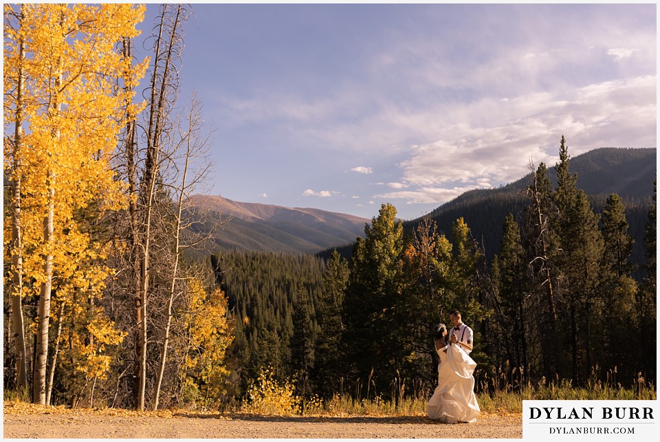winter park mountain lodge wedding colorado bride and groom dancing in forest along road