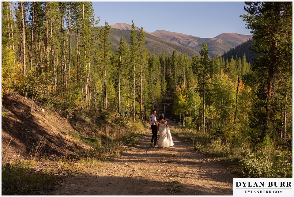 winter park mountain lodge wedding colorado bride and groom walking down the mountain