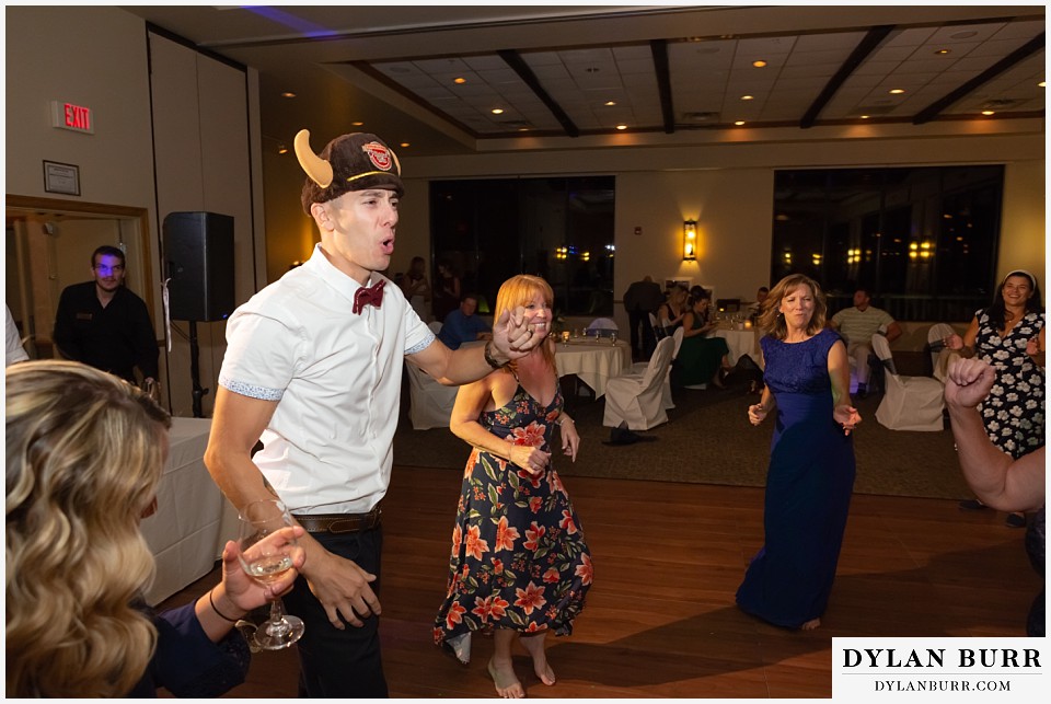 winter park mountain lodge wedding colorado groom dancing with hat on