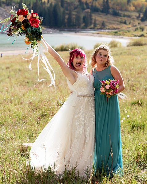 bride and maid of honor having fun at maroon bells wedding colorado